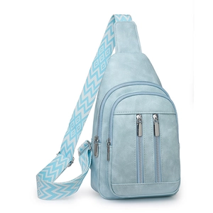 Detail of light blue crossbody bag featuring matte texture and geometric woven strap
