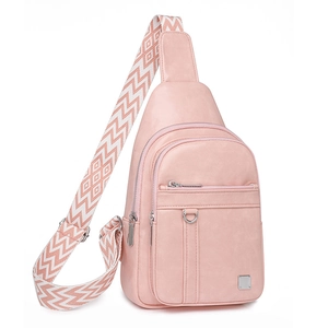 Detail of pink sling bag with ethnic geometric pattern wide strap and matte PU texture