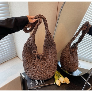 Detail of dark coffee hollow knit hobo bag with intricate mesh weave and sturdy strap