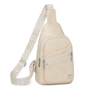 Detail view of beige crossbody chest bag with decorative geometric woven strap and zippers