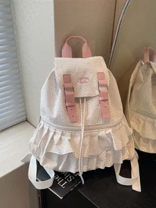 Pink and white polka dot backpack with ruffled trim and 'Hello' embroidery detail