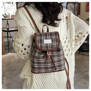 Chic plaid small backpack with leather trim and drawstring shown on a model
