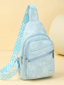 Light blue crossbody chest bag with geometric wide strap and three zipper compartments