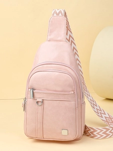 Pink faux leather crossbody sling bag with dual zippers and woven wide shoulder strap