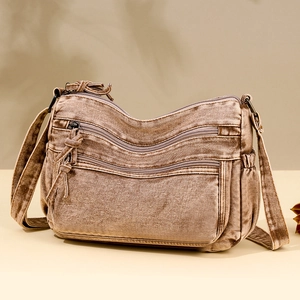 Crossbody bag in brown washed fabric with multi-zipper pockets and wide shoulder strap