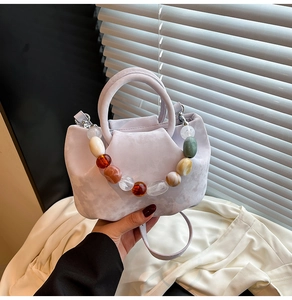 Détail du sac seau plissé lilas avec poignée en perles de résine colorées chic