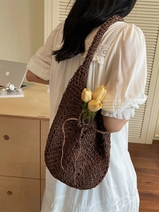 Hollow out crochet shoulder bag in dark brown with tulips on a minimalist desk