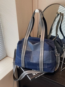 Denim patchwork tote bag with contrast stitching and wide striped shoulder strap