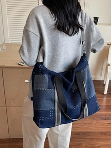 Patchwork denim tote bag with striped handles and adjustable shoulder strap for women
