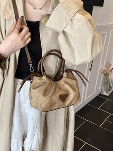Brown pleated shoulder bag with vintage texture and triangular logo for daily commute