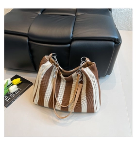 Detail of knit stripe tote bag showing the vertical brown and white pattern texture