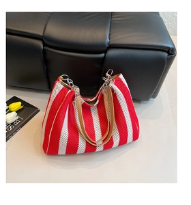 Close-up of red and white striped mesh tote with leather and metal chain handle