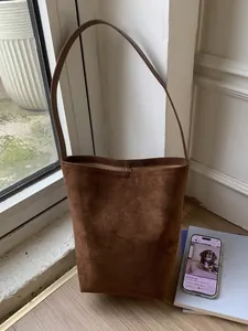 Retro dark brown suede bucket shoulder bag with minimalist design for daily commute