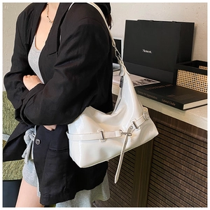Detail of white glossy hobo bag with adjustable buckle strap and polished leather texture