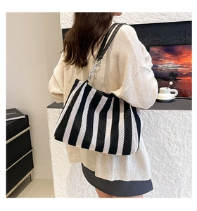 Fashionable black and white vertical striped woven tote bag with leather shoulder straps