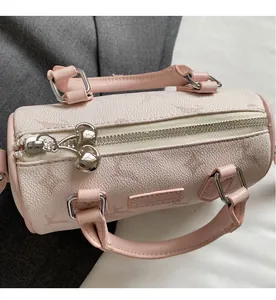 Top detail of pink pebbled leather Boston bag with dual smooth silver metal zippers