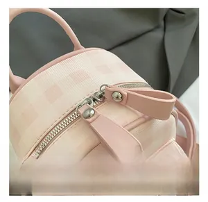 Detail showing the double zipper closure and pink checkerboard woven texture
