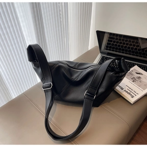 Detailed view of black soft leather hobo bag with silver zipper and textured finish