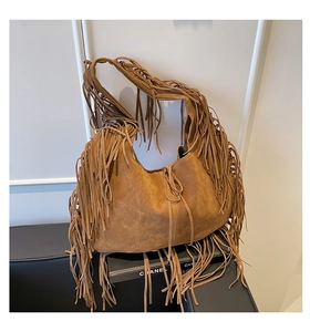 Detailed view of bohemian brown suede tote bag featuring dense tassel fringe decoration