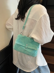 Vintage mint green denim crossbody bag with adjustable strap and silver snap button
