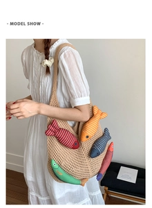 Detail of knitted tote bag featuring colorful fish-shaped plush charms on beige fabric