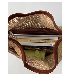 Top view of spacious straw tote bag showing large capacity and brown leather trim detail