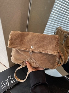 Vintage brown canvas crossbody bag with multiple pockets and rustic metal hardware