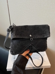 Vintage black denim crossbody bag with white stitching and adjustable shoulder strap