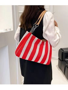 Striped woven tote bag with red and white patterns and leather shoulder strap handles