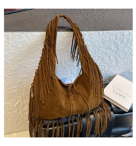 Brown suede bohemian shoulder bag with long fringe tassels and retro aesthetic detail