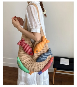 Detail of beige crochet tote bag featuring colorful 3D knitted fish charms for women