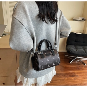 Detail of Boston bag with deer print, leather texture and adjustable shoulder strap