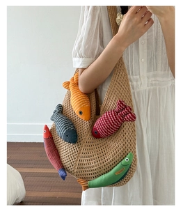 Detail of bohemian knitted tote bag with five colorful plush fish-shaped pendants