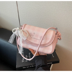 Detail of pink plaid crossbody bag with pearl lace bow charm and heart embroidery
