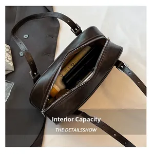 Interior capacity of vintage brown shoulder bag showing makeup storage and lining