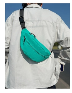 Detail of mint green waterproof nylon chest bag with black adjustable strap and buckle
