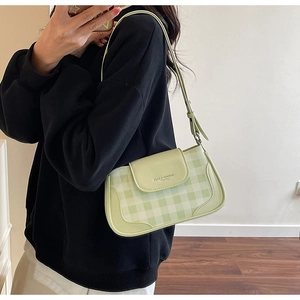 Modella che indossa una borsa a tracolla a scacchi verde menta con tracolla regolabile giornaliera