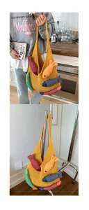 Detail of yellow knit crochet tote bag with five colorful striped fish doll pendants