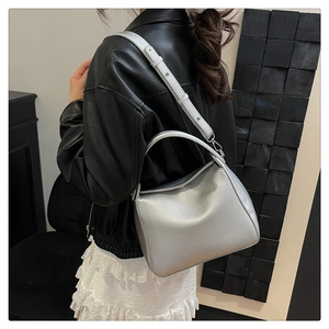 Close-up of silver lychee texture leather bag with sleek zipper and metallic finish