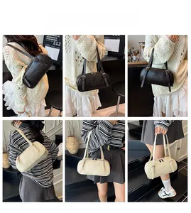 Detail view of cylinder shoulder bag with embossed letters in coffee and beige colors