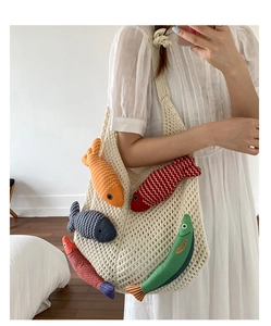 Detail of beige crochet tote bag with five colorful 3D fish dolls and hollow mesh knit pattern