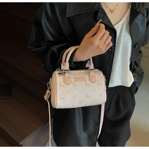 Detail of a pink Boston bag featuring deer print and adjustable crossbody strap