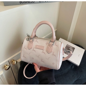 Detail of light pink Boston bag with elk pattern, featuring silver hardware and top handles