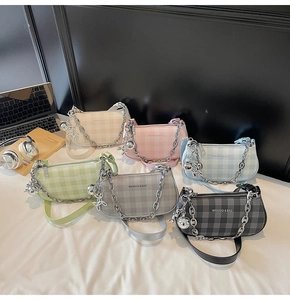 Group display of plaid baguette bags in six colors with silver chains and dog charms