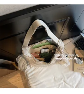 Spacious interior of beige nylon crossbody bag showing large capacity for daily items