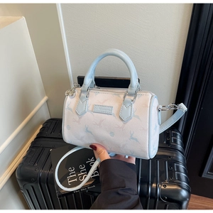 Detail of mini Boston bag featuring light blue deer prints and detachable shoulder strap