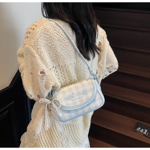 Detail of light blue plaid square bag with lace pearl pendant and heart embroidery