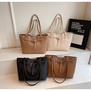 Detailed view of large tote bags in four neutral colors featuring lychee grain leather