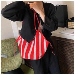 Detail of red and white striped mesh tote bag with breathable hollow design