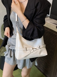 Glossy white half-moon underarm bag with buckle detail worn with a black blazer